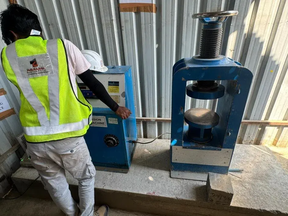Engineer operating a compression testing machine